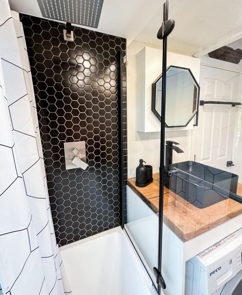 Small bathroom with black hexagonal tiles