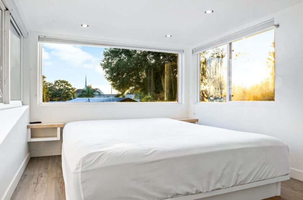 Huge windows in a tiny house bedroom